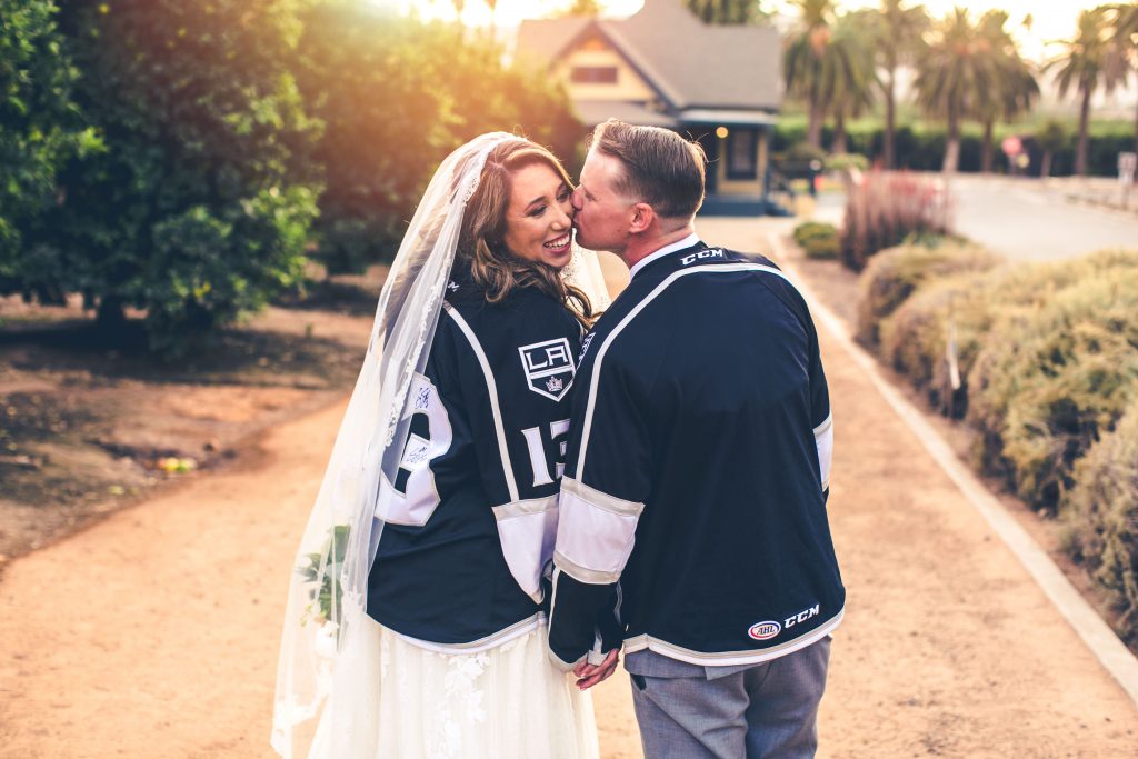 The bride and the groom wearing jerseys of the KING hockey team
